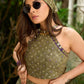 Vibrant Mehendi green and purple bandhani lehenga paired with a mirror work halter neck choli and matching dupatta.