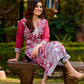 Rich mulberry pink kurta showcasing all-over Kalamkari print with balanced white and black accents