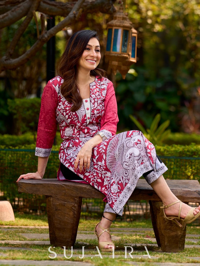Rich mulberry pink kurta showcasing all-over Kalamkari print with balanced white and black accents