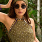 Vibrant Mehendi green and purple bandhani lehenga paired with a mirror work halter neck choli and matching dupatta.