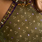 Vibrant Mehendi green and purple bandhani lehenga paired with a mirror work halter neck choli and matching dupatta.