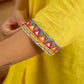 Traditional madhubani hand painting enhances this bright yellow cotton top.