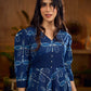 Indigo printed dress featuring dragonfly motifs, gathered sleeves with cuffs, and navy blue pleated waist detailing accented with pearls, creating a graceful silhouette with refined artisanal charm.