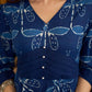 Indigo printed dress featuring dragonfly motifs, gathered sleeves with cuffs, and navy blue pleated waist detailing accented with pearls, creating a graceful silhouette with refined artisanal charm.