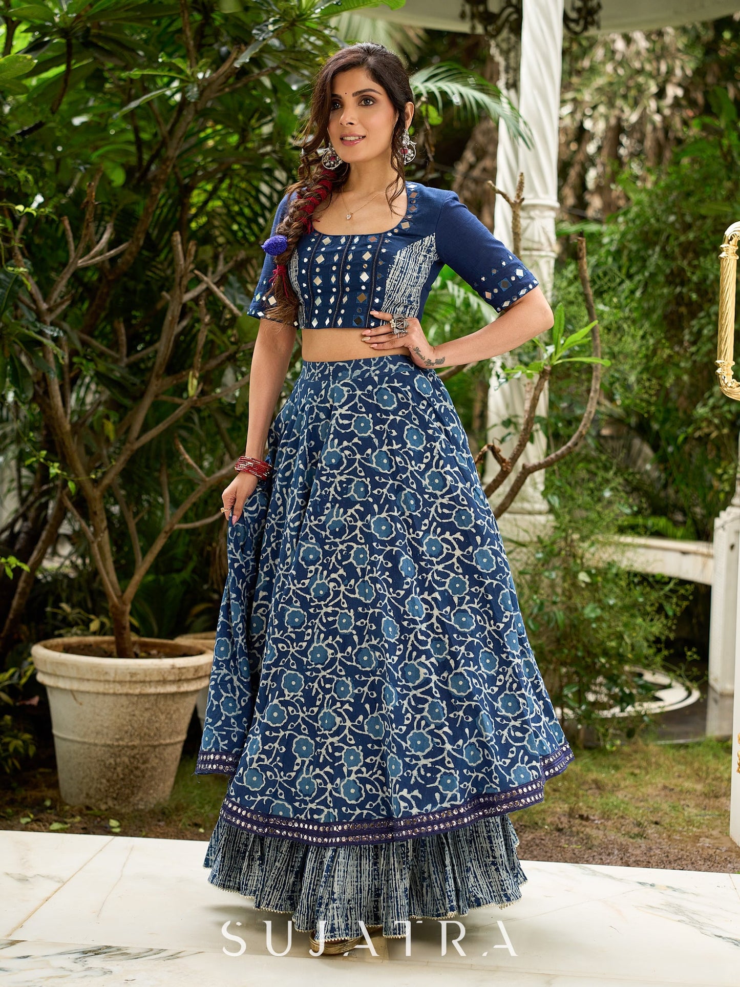 Modern folkloric layered indigo lehenga beautifully contrasted with a luminous full mirror work choli - Lehriya dupatta optional.