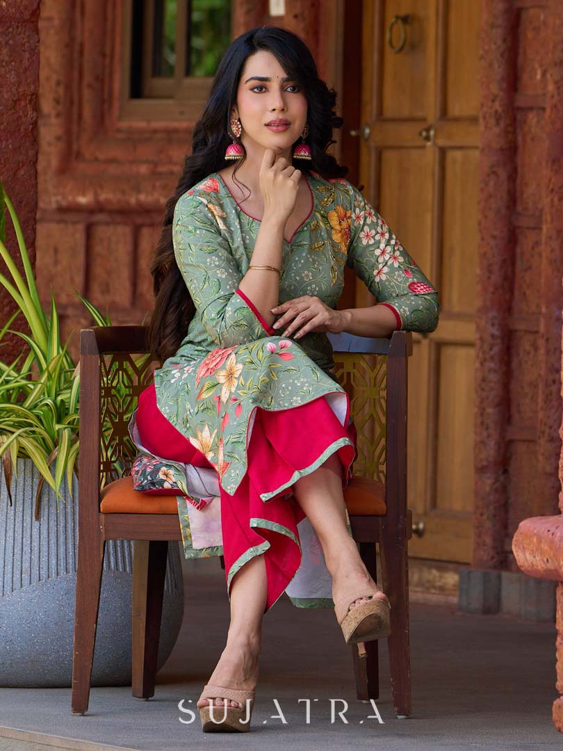 Soft green printed kurta with vibrant floral motifs, highlighted with hand embroidery and bright magenta accents.