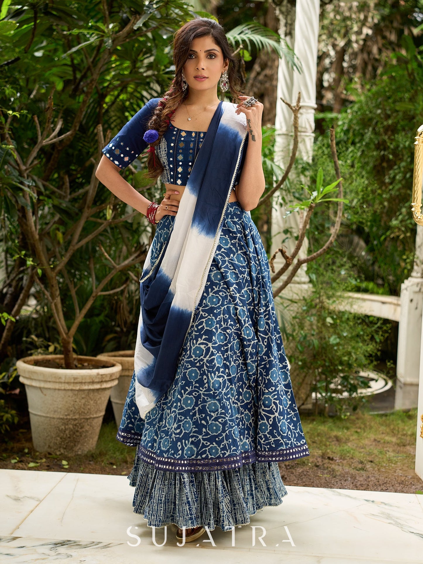Modern folkloric layered indigo lehenga beautifully contrasted with a luminous full mirror work choli - Lehriya dupatta optional.
