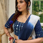Modern folkloric layered indigo lehenga beautifully contrasted with a luminous full mirror work choli - Lehriya dupatta optional.