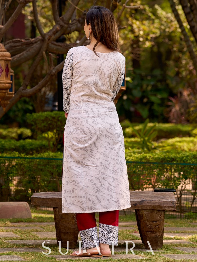 Elegant off-white and black kurta featuring Madhubani fish motifs with rich maroon accents