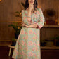Soft green Gulmohar-printed dress featuring a square neckline and pearl-highlighted motifs, finished with an elasticated waist to create a flattering cinched silhouette with effortless charm.