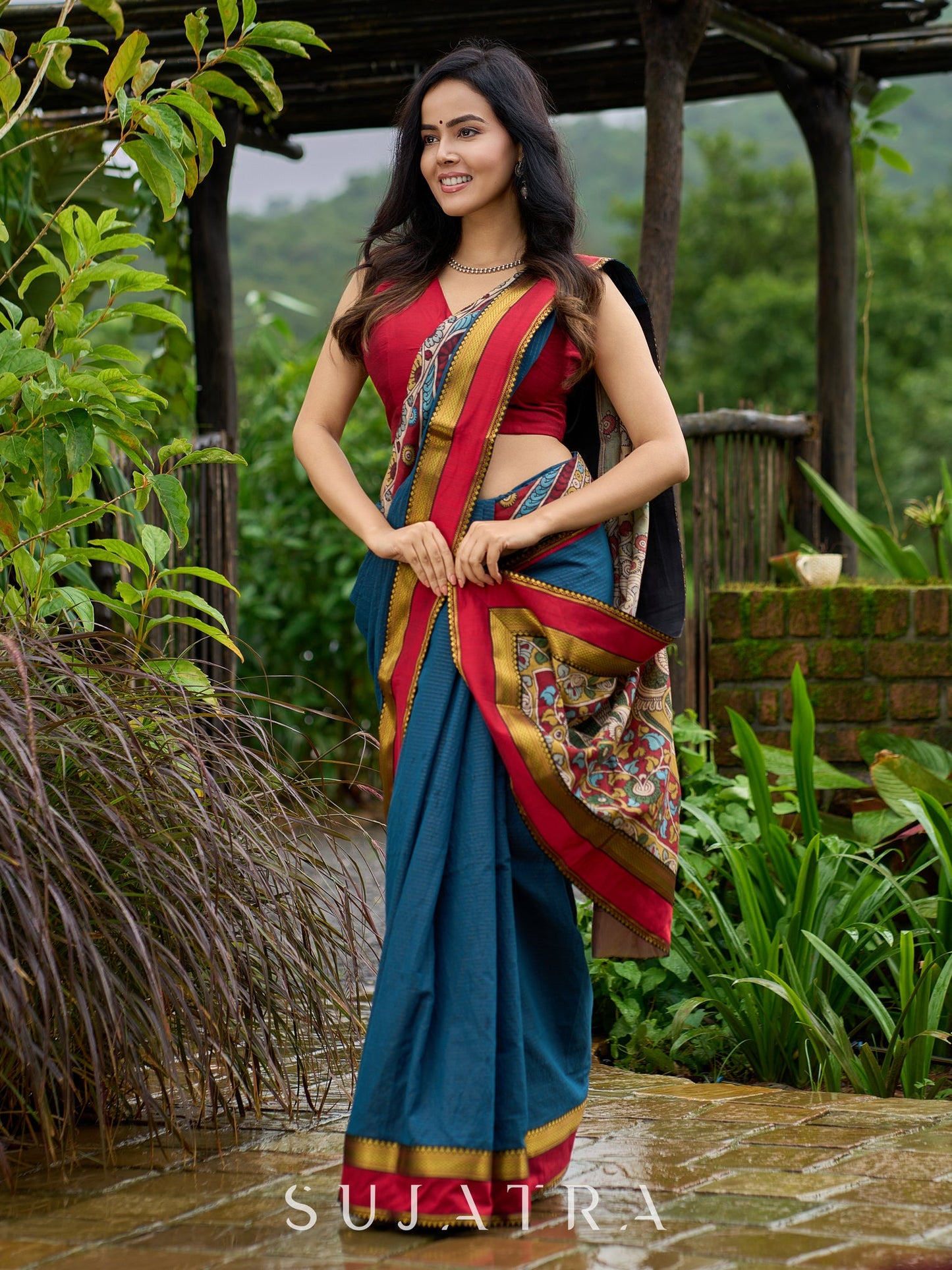 Elegant striped cotton saree in teal, enriched with hand-painted Kalamkari pallu