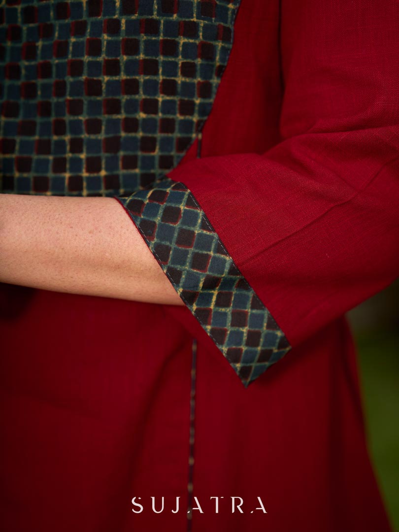 Chic maroon dress featuring a contrasting teal neck patch with charming Peter Pan collar details