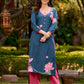 Graceful teal kurta with delicate pink lotus printing, subtle pink accents, and a statement patch above the neckline.