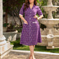 Purple Ikat dress with a notch collar, softly gathered sleeves, crisp white accents, a gently gathered upper waist, and functional slip-in pockets.