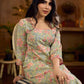 Soft green Gulmohar-printed dress featuring a square neckline and pearl-highlighted motifs, finished with an elasticated waist to create a flattering cinched silhouette with effortless charm.