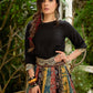 Modern colourful Ajrakh lehenga beautifully contrasted by a sleek black gathered topwear.
