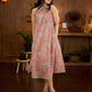 Soft peachy pink floral halter-neck dress with fresh green accents, crafted in a bias-cut silhouette that creates graceful flow and a fluid drape for an effortless summer look.