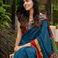 Elegant striped cotton saree in teal, enriched with hand-painted Kalamkari pallu