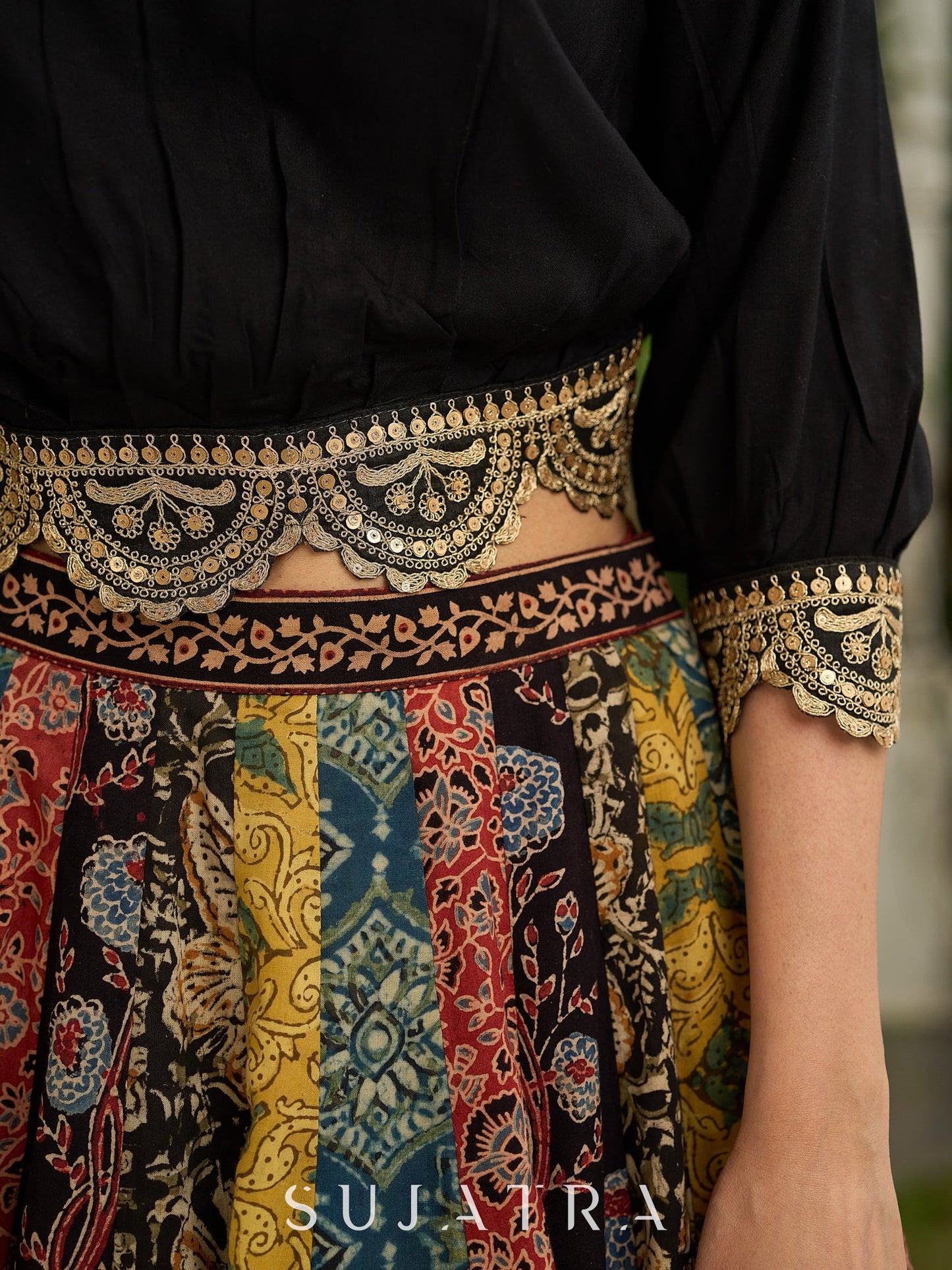 Modern colourful Ajrakh lehenga beautifully contrasted by a sleek black gathered topwear.