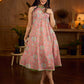 Soft peachy pink floral halter-neck dress with fresh green accents, crafted in a bias-cut silhouette that creates graceful flow and a fluid drape for an effortless summer look.