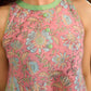 Soft peachy pink floral halter-neck dress with fresh green accents, crafted in a bias-cut silhouette that creates graceful flow and a fluid drape for an effortless summer look.