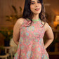 Soft peachy pink floral halter-neck dress with fresh green accents, crafted in a bias-cut silhouette that creates graceful flow and a fluid drape for an effortless summer look.