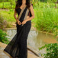 Classic black cotton saree featuring intricate weave and radiant zari edges