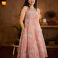 Soft peachy pink floral halter-neck dress with fresh green accents, crafted in a bias-cut silhouette that creates graceful flow and a fluid drape for an effortless summer look.