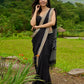 Classic black cotton saree featuring intricate weave and radiant zari edges