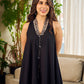 Modern black bias-cut dress showcasing unique artisan-inspired Kalamkari neck trim.