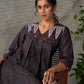 Black Ajrakh printed dress with pleats, maroon accents, and silver embellishments.
