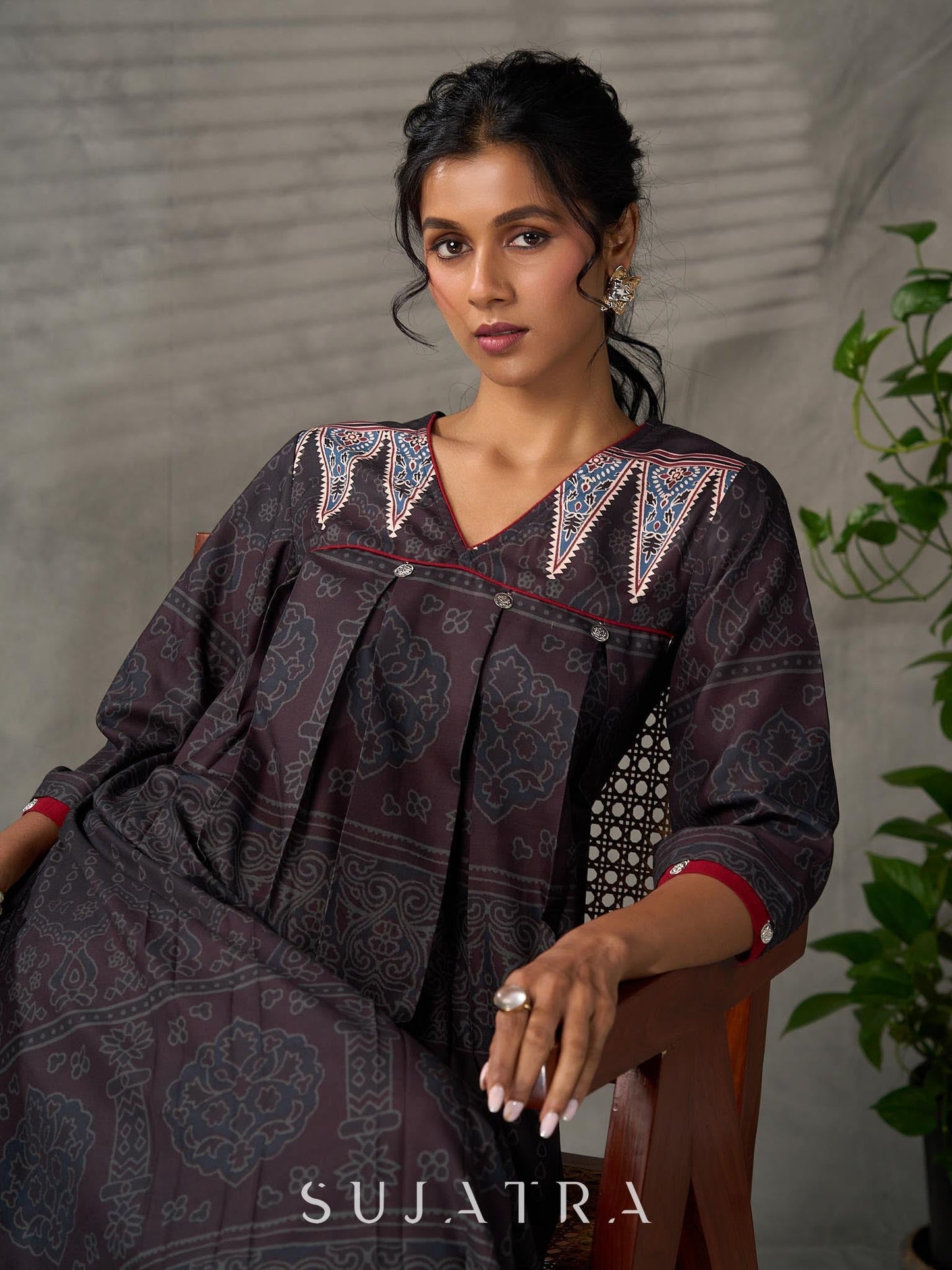 Black Ajrakh printed dress with pleats, maroon accents, and silver embellishments.