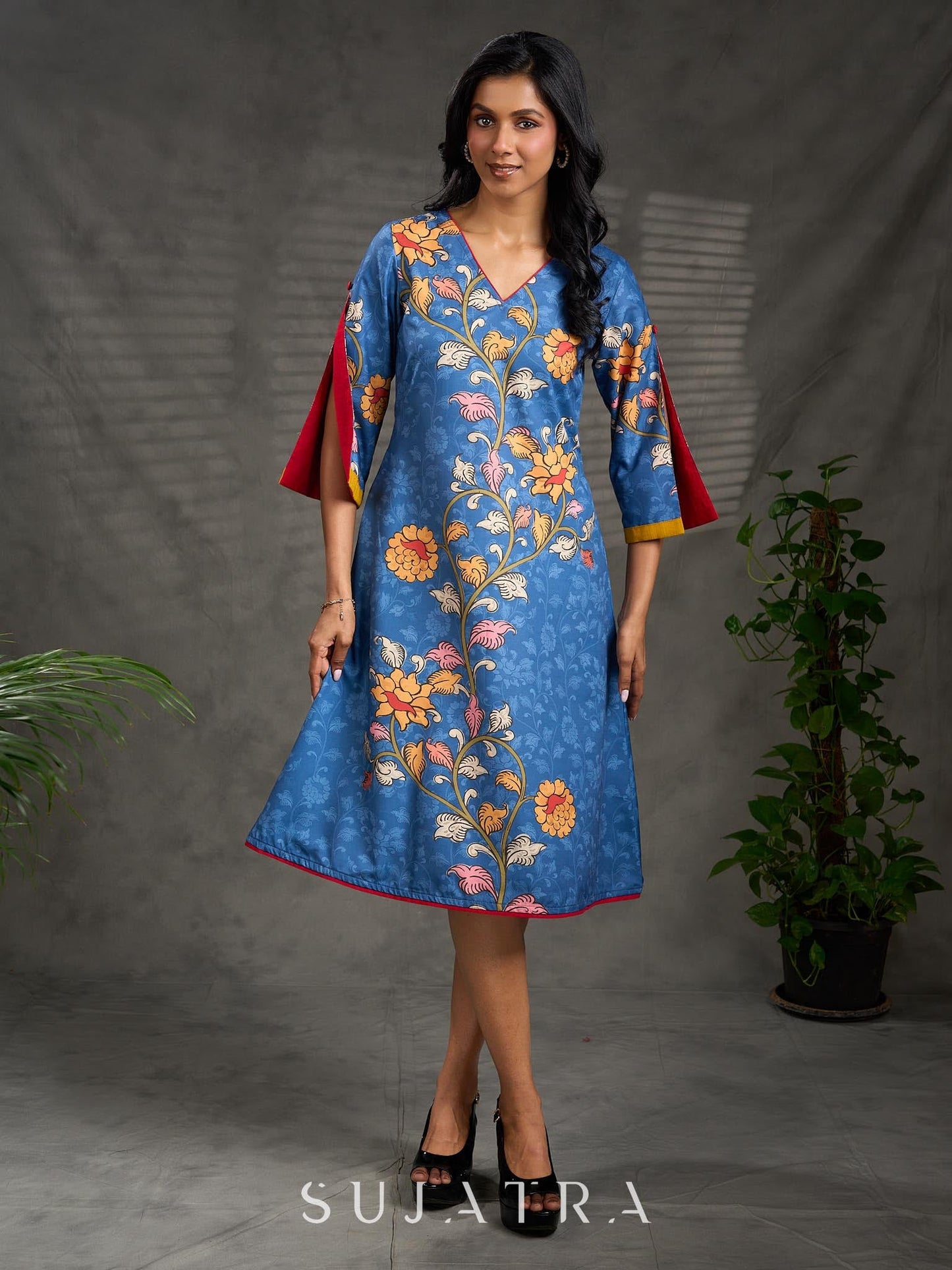 Indigo Kalamkari printed dress with vibrant red and mustard accents.