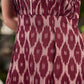 Statement maroon Ikat sleeveless dress elevated with pintuck detailing through the bodice and box pleats beyond the darts for a soft, flowing finish.