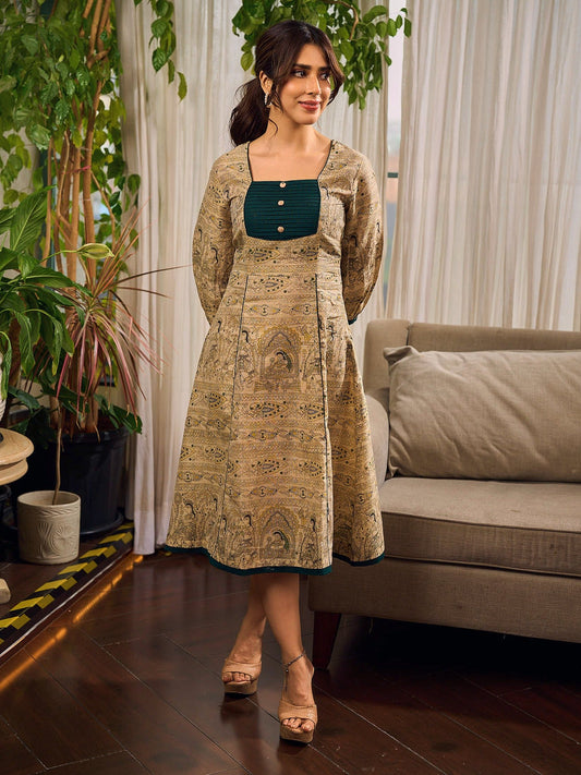 Artisanal beige Madhubani dress featuring intricate motifs, a contrasting green yoke, and refined accents.
