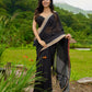 Classic black cotton saree featuring intricate weave and radiant zari edges