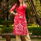 Culturally rooted red kurta displaying classic Warli designs with subtle beige touches