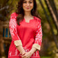 Culturally rooted red kurta displaying classic Warli designs with subtle beige touches