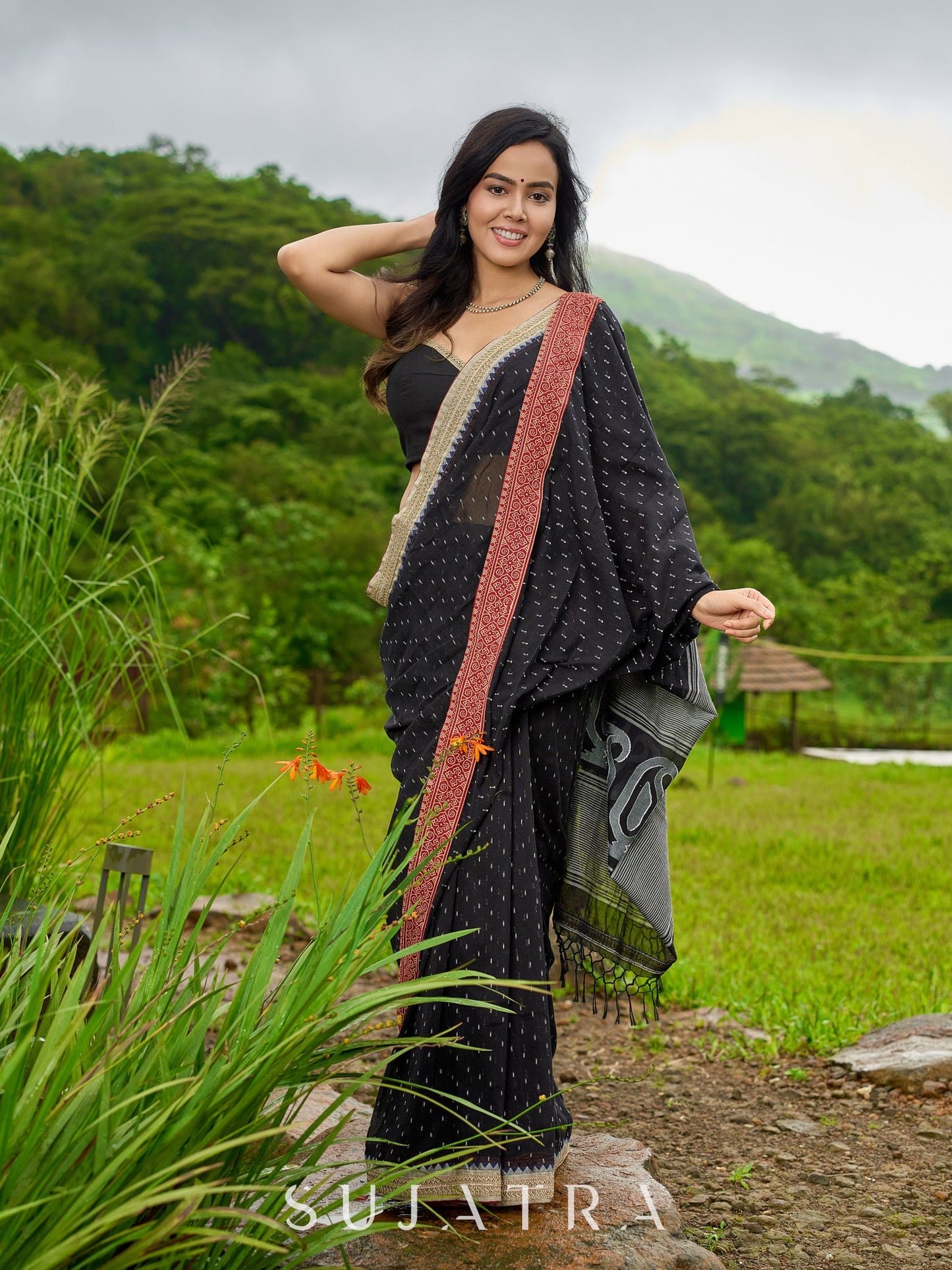 Classic black cotton saree featuring intricate weave and radiant zari edges
