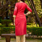 Culturally rooted red kurta displaying classic Warli designs with subtle beige touches