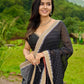 Classic black cotton saree featuring intricate weave and radiant zari edges