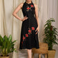 Stunning black rayon dress adorned with vibrant floral block print accents