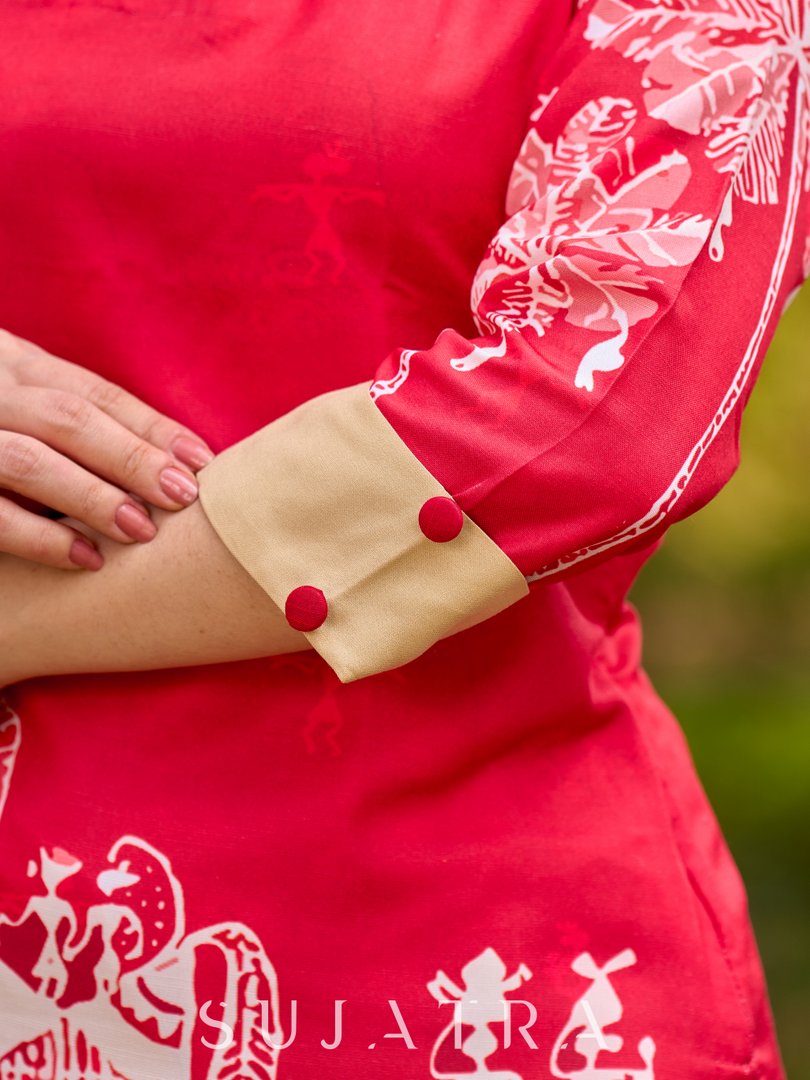 Culturally rooted red kurta displaying classic Warli designs with subtle beige touches
