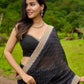 Classic black cotton saree featuring intricate weave and radiant zari edges