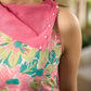 Summer pink floral sleeveless dress featuring an asymmetrical cowl collar and delicate pearl accents, creating a soft, fluid silhouette with a touch of elegant, contemporary charm.
