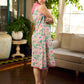 Summer pink floral sleeveless dress featuring an asymmetrical cowl collar and delicate pearl accents, creating a soft, fluid silhouette with a touch of elegant, contemporary charm.