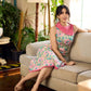 Summer pink floral sleeveless dress featuring an asymmetrical cowl collar and delicate pearl accents, creating a soft, fluid silhouette with a touch of elegant, contemporary charm.
