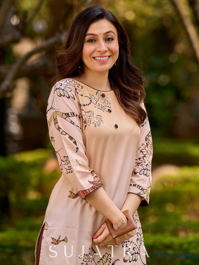 Artisanal cream kurta adorned with Gond-inspired motifs and classic brown accents