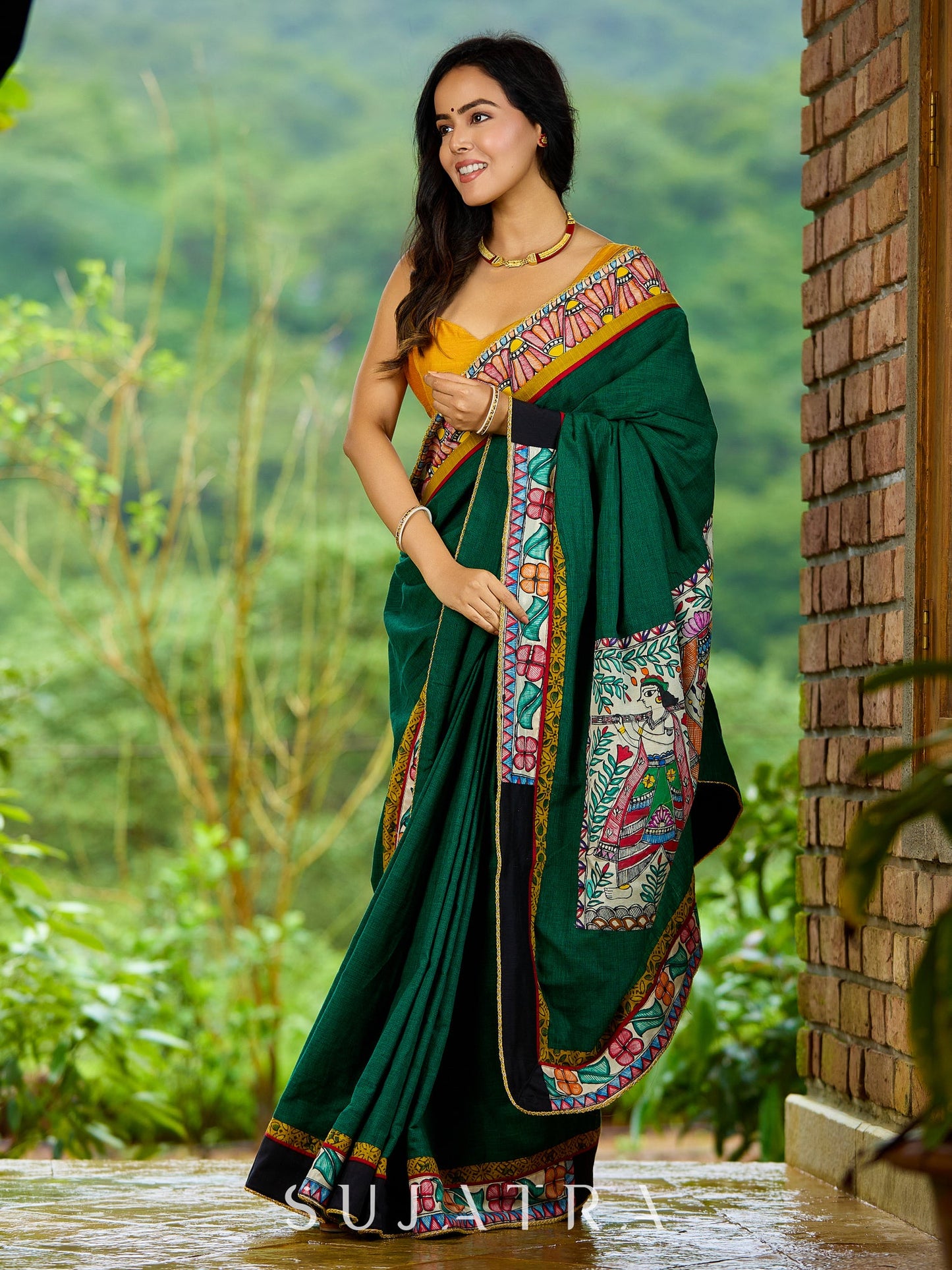 Artisanal cotton saree in bold green with Madhubani hand painted charm