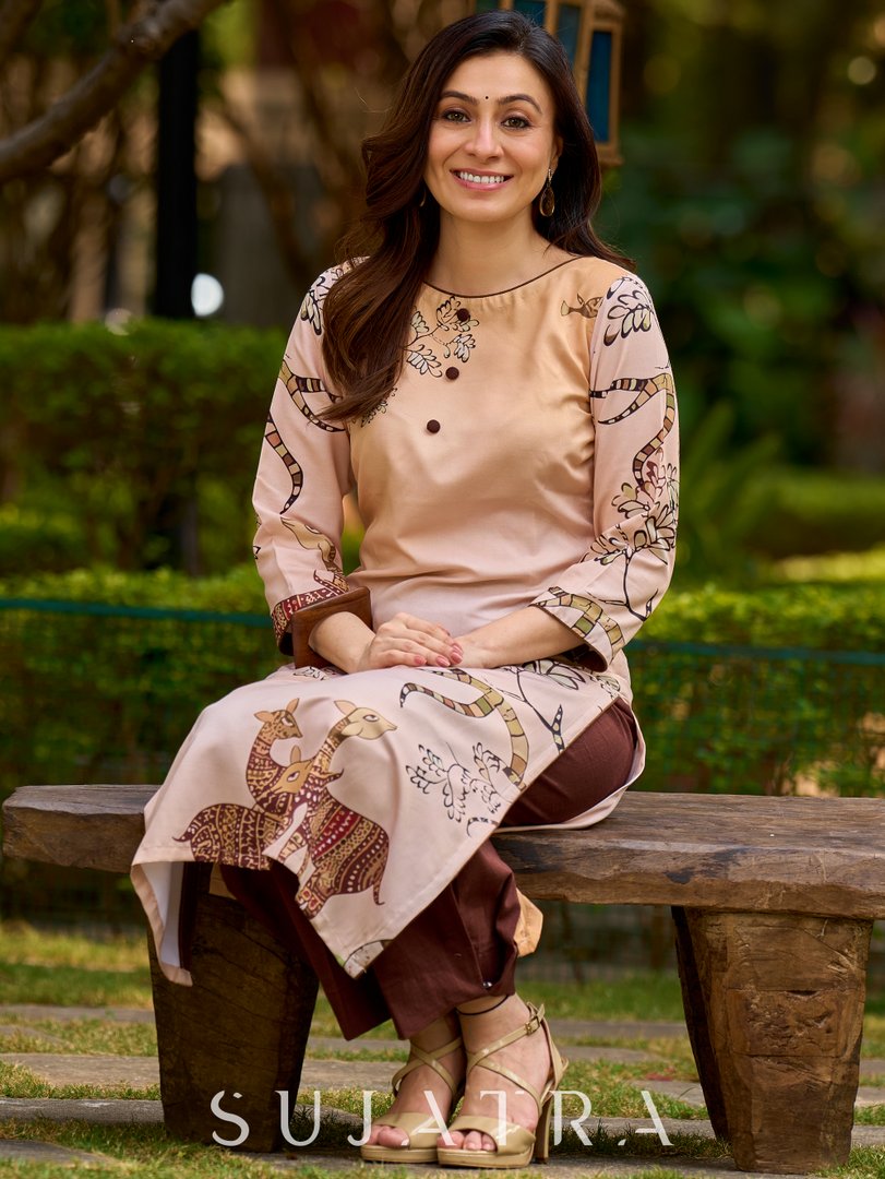Artisanal cream kurta adorned with Gond-inspired motifs and classic brown accents